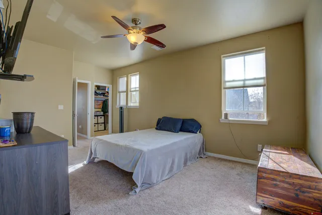 a bedroom with a bed and a desk