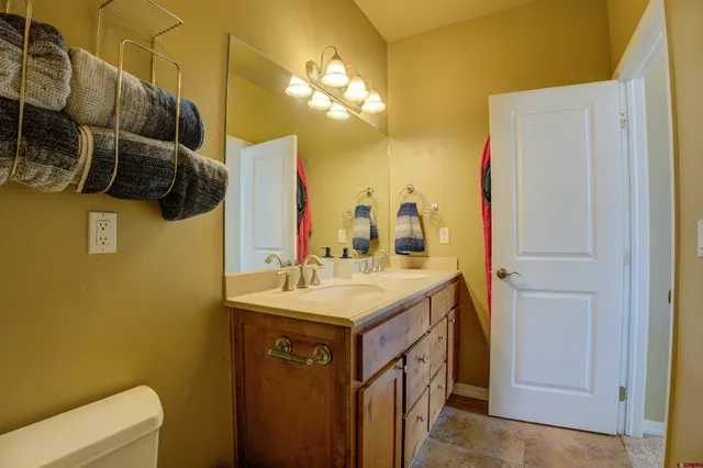 a bathroom with a sink a light fixture and a toilet