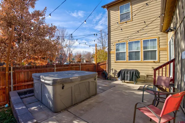a view of a patio with a table and chairs