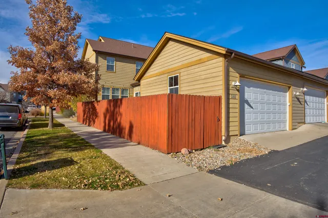 a view of a house with wooden fence