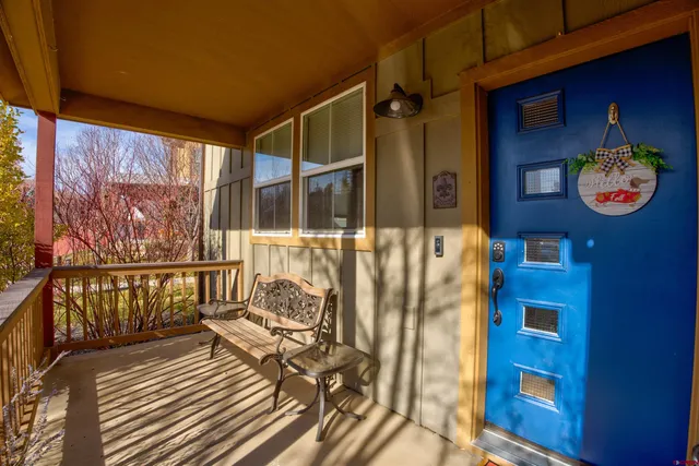 a view of a balcony with chairs and wooden floor