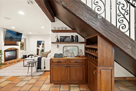 a living room with furniture a flat screen tv and kitchen view