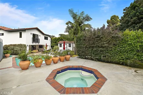 a house view with swimming pool and sitting space