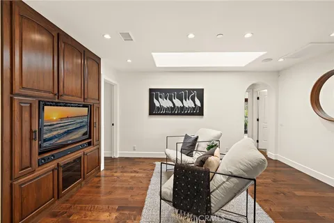 a living room with furniture a dining table and wooden floor