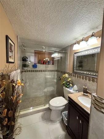a bathroom with a sink a toilet and mirror