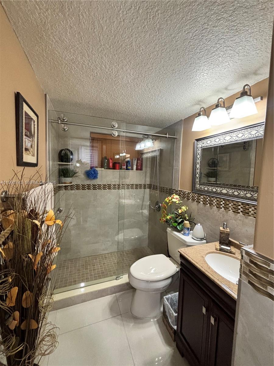 2310 West 74th Street, Unit 103 Hialeah, FL 33016 - Photo 12 of 18 a bathroom with a sink a toilet and mirror