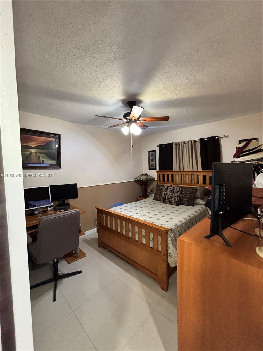 2310 West 74th Street, Unit 103 Hialeah, FL 33016 - Photo 18 of 18 a living room with furniture and a chandelier