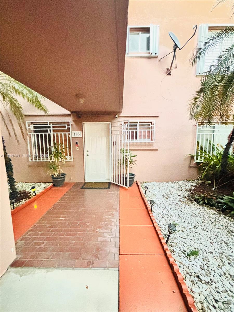 2310 West 74th Street, Unit 103 Hialeah, FL 33016 - Photo 2 of 18 a front view of a house with trees