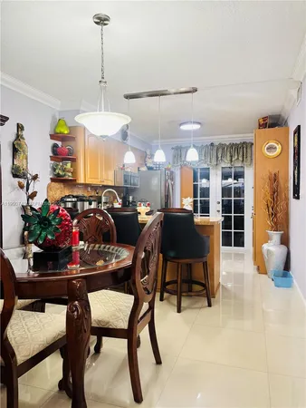 a view of a dining room with furniture and chandelier