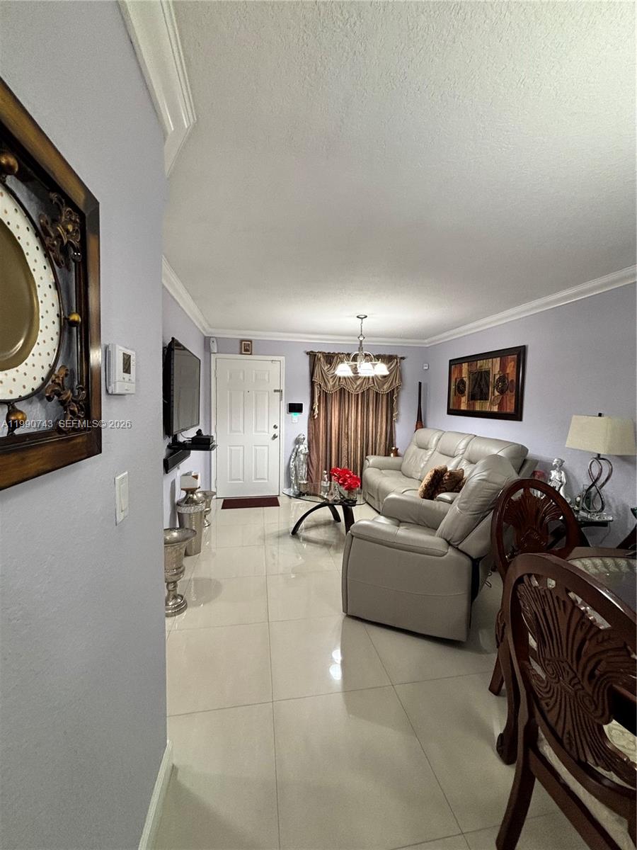 2310 West 74th Street, Unit 103 Hialeah, FL 33016 - Photo 6 of 18 a living room with furniture and a flat screen tv
