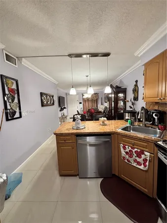 a kitchen with stainless steel appliances granite countertop a sink and a stove