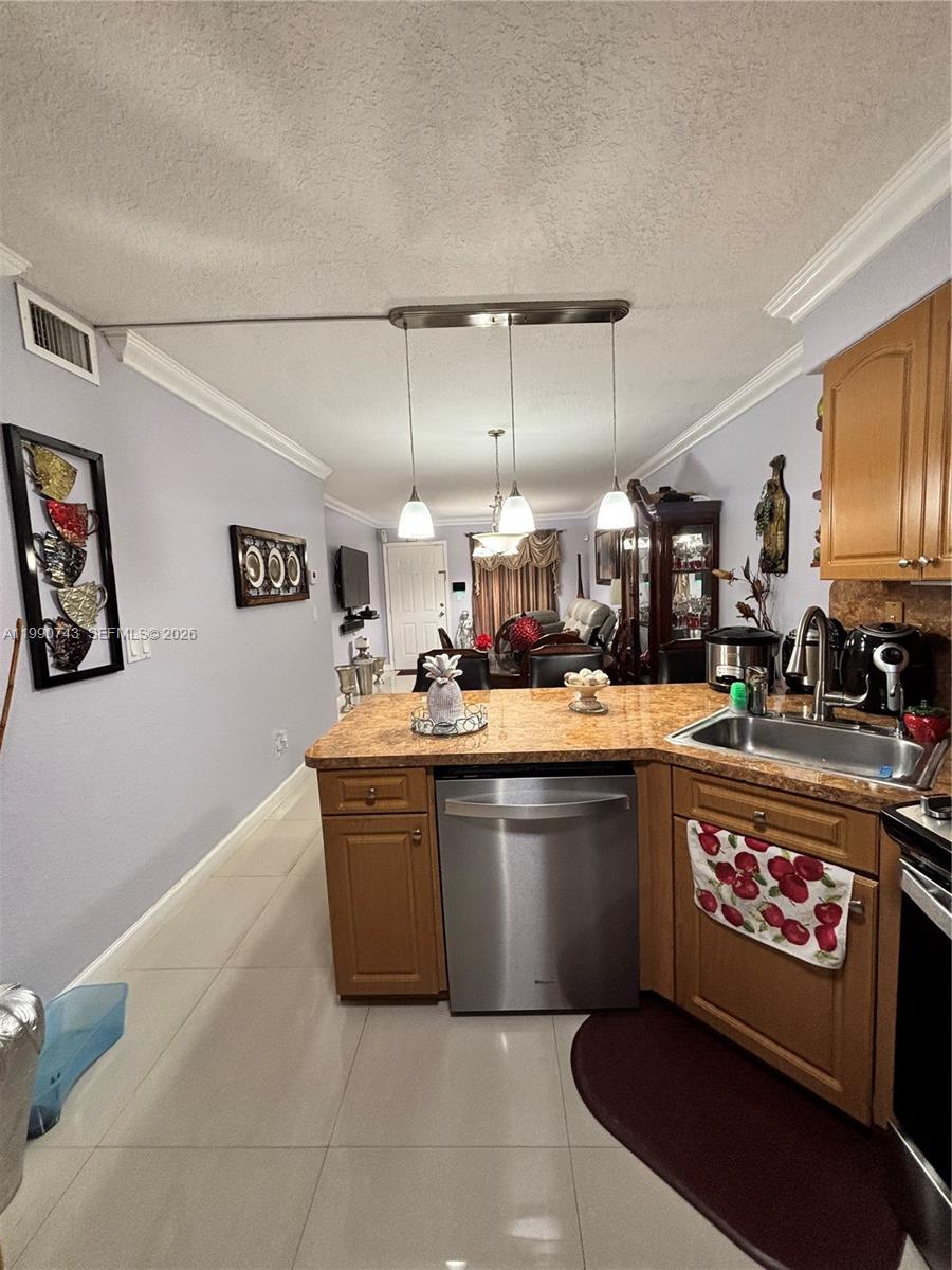 2310 West 74th Street, Unit 103 Hialeah, FL 33016 - Photo 7 of 18 a kitchen with stainless steel appliances granite countertop a sink and a stove