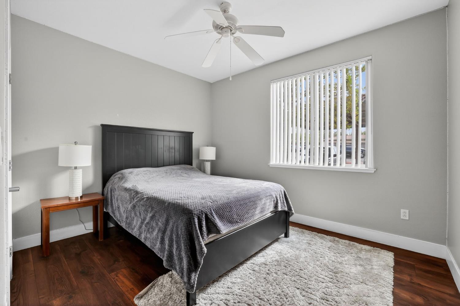 1501 Secret Ravine Parkway, Unit 1916 Roseville, CA 95661 - Photo 13 of 41 a bedroom with a bed rug and wooden floor