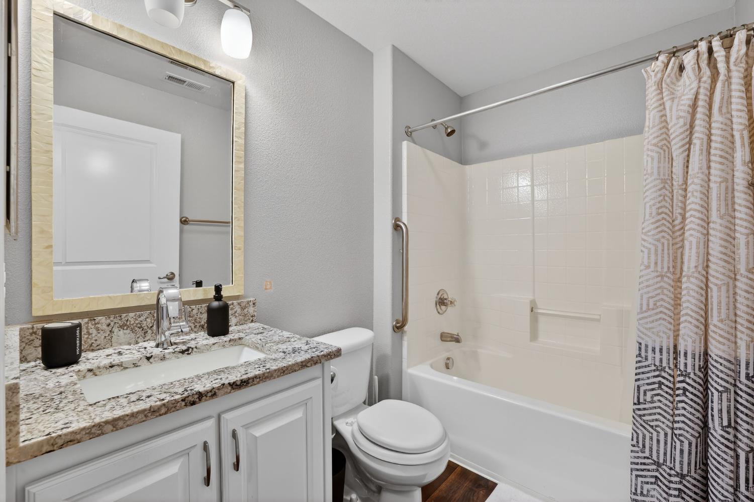 1501 Secret Ravine Parkway, Unit 1916 Roseville, CA 95661 - Photo 14 of 41 a bathroom with a granite countertop sink toilet and shower