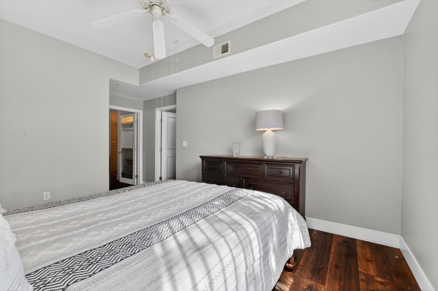 1501 Secret Ravine Parkway, Unit 1916 Roseville, CA 95661 - Photo 26 of 41 a bedroom with a bed and wooden floor