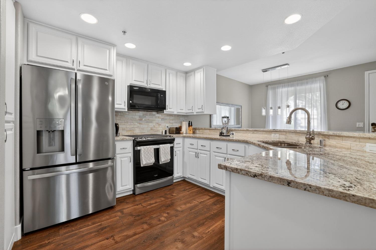 1501 Secret Ravine Parkway, Unit 1916 Roseville, CA 95661 - Photo 3 of 41 a kitchen with granite countertop a refrigerator stove top oven and sink