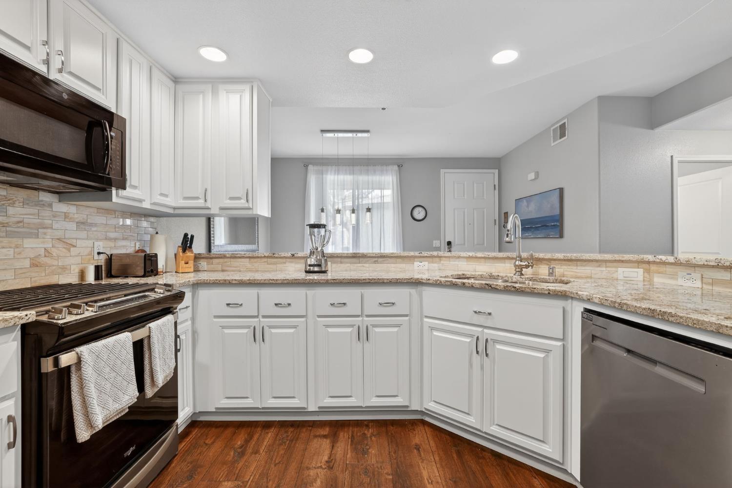 1501 Secret Ravine Parkway, Unit 1916 Roseville, CA 95661 - Photo 5 of 41 a kitchen with granite countertop cabinets stainless steel appliances and a sink