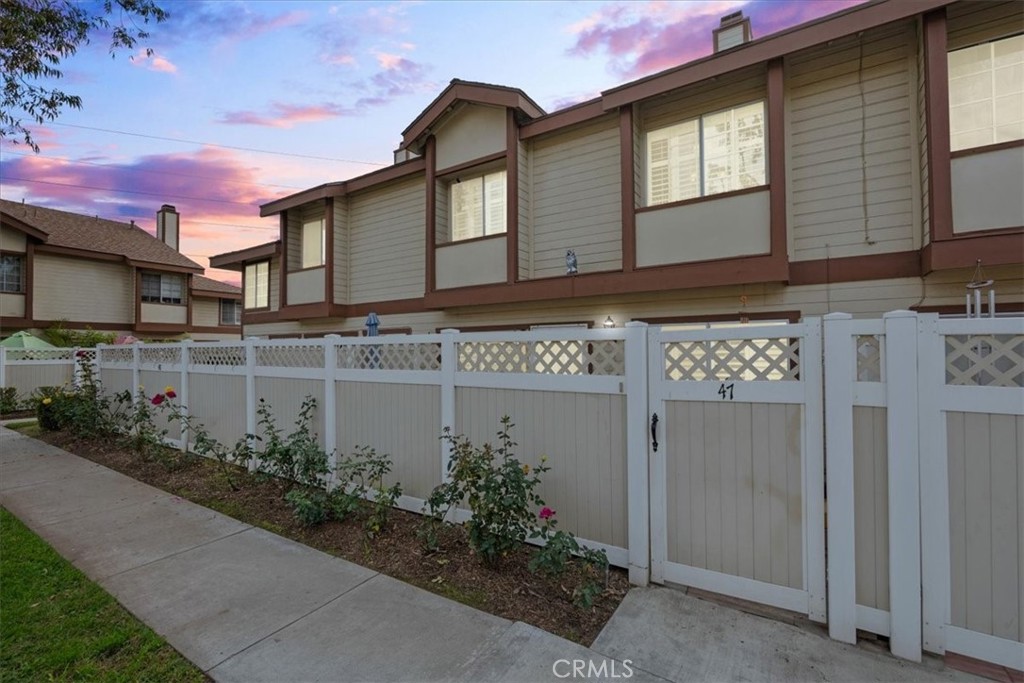 a front view of a house with plants