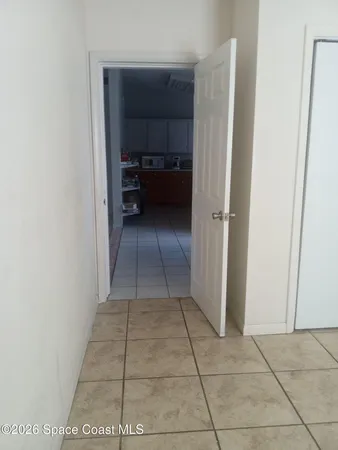 a view of a closet in kitchen and an empty room