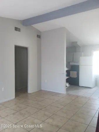 a view of a room with a barbeque and entryway