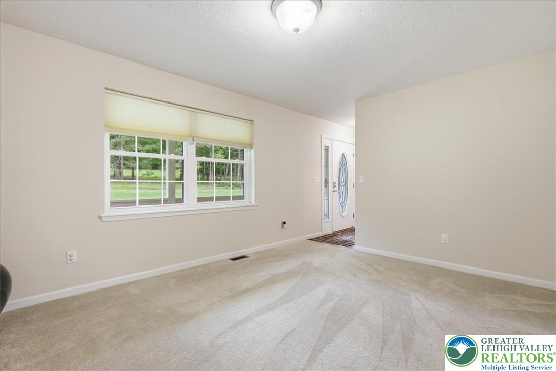 5032 Custard Road Stroudsburg, PA 18360 - Photo 17 of 80 Plush carpeting and abundant natural light create a welcoming transition from the front entry.