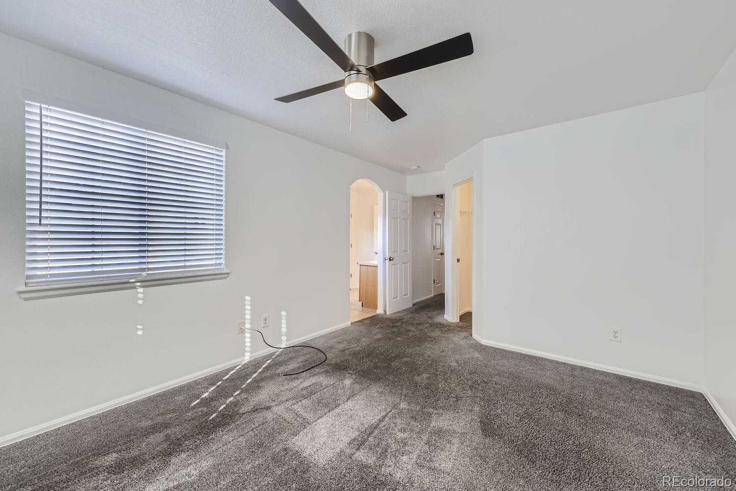 4512 Cornish Way Denver, CO 80239 - Photo 16 of 35 a view of a livingroom with a ceiling fan and window