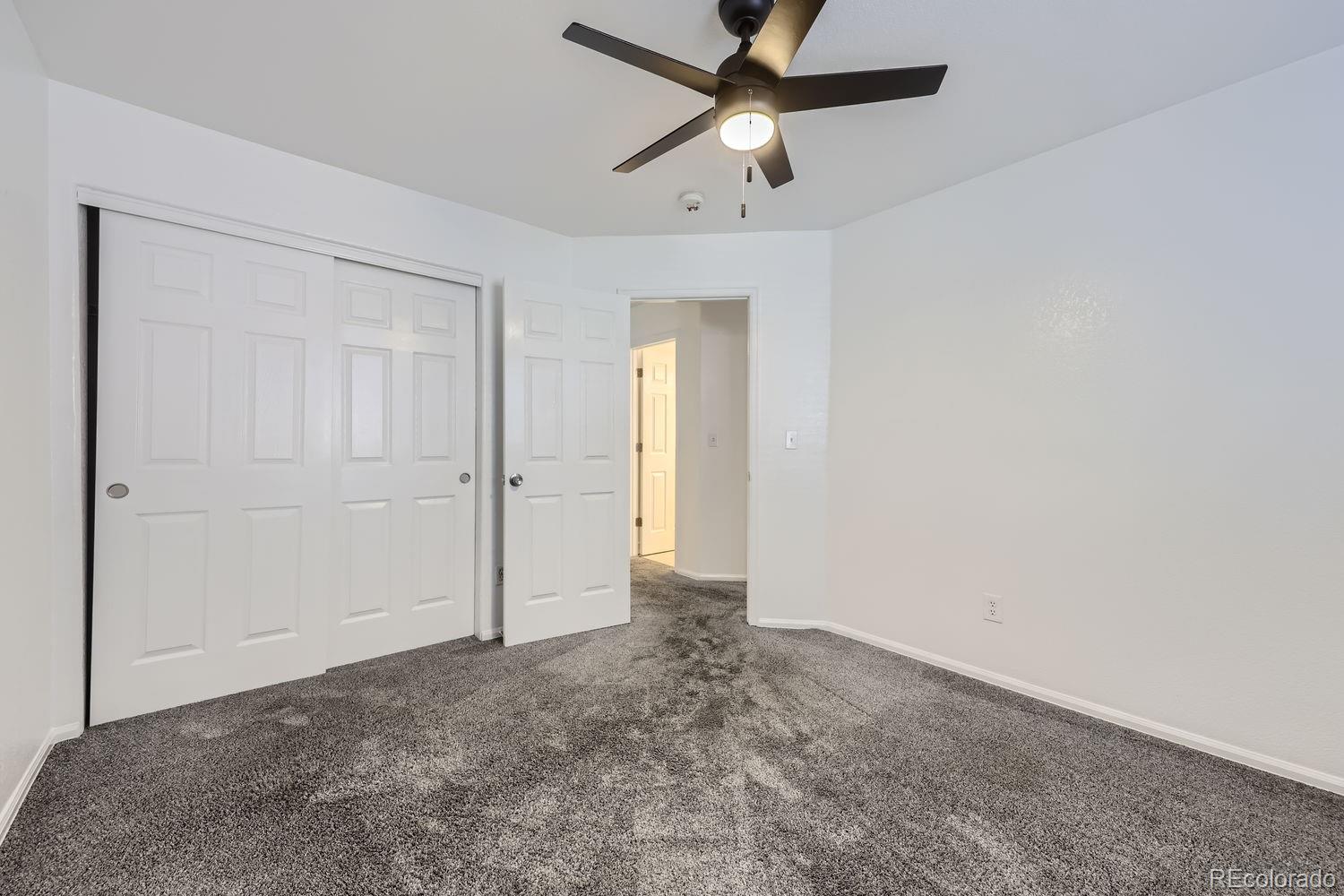 4512 Cornish Way Denver, CO 80239 - Photo 20 of 35 an empty room with closet and fan