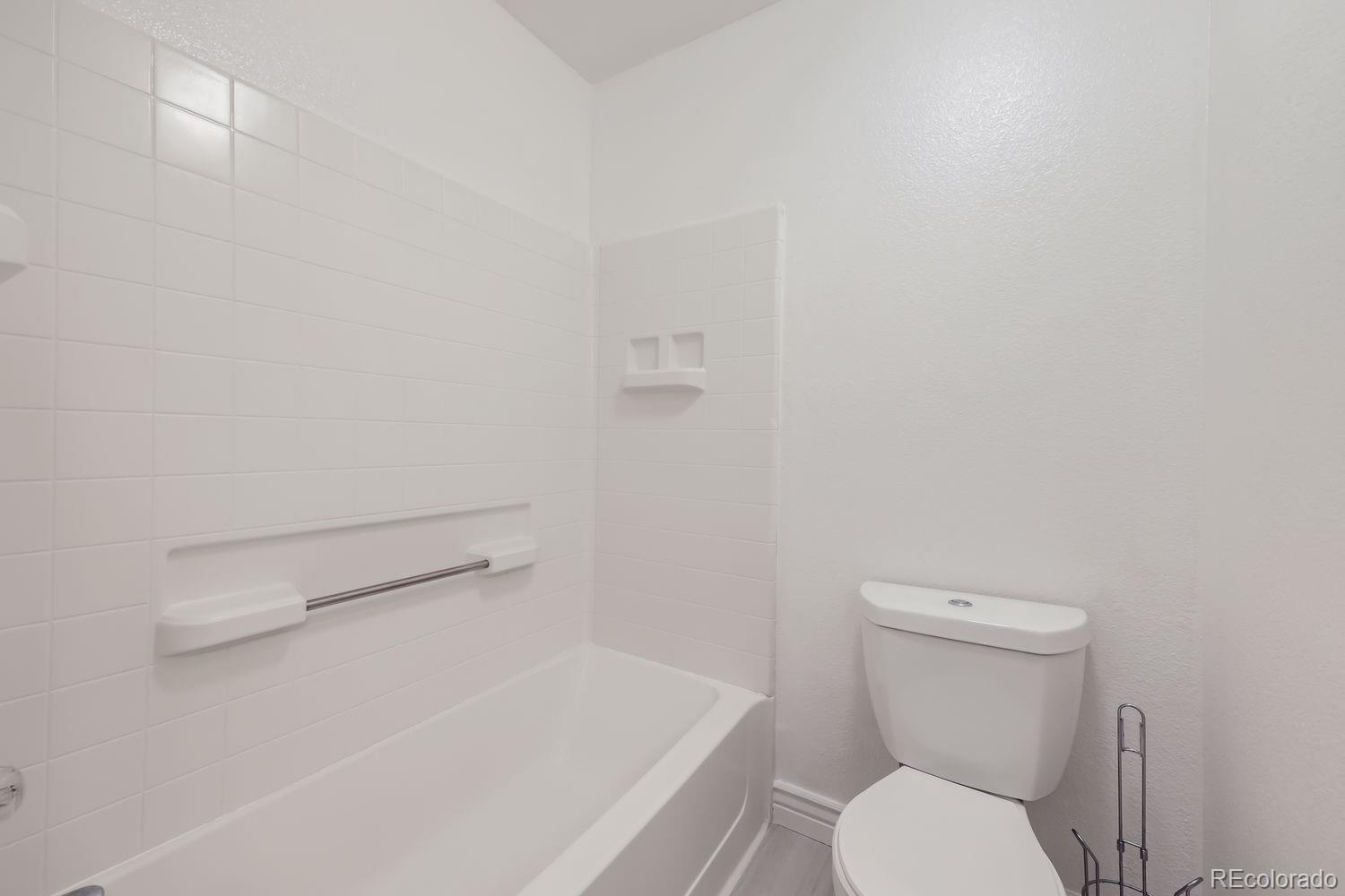 4512 Cornish Way Denver, CO 80239 - Photo 23 of 35 a white toilet sitting next to a shower
