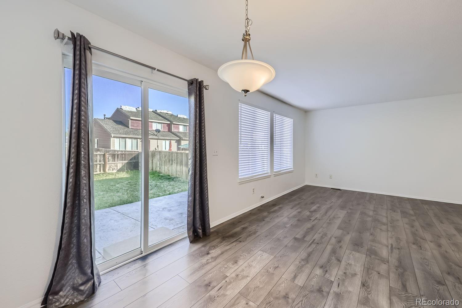 4512 Cornish Way Denver, CO 80239 - Photo 9 of 35 a view of an empty room with a window