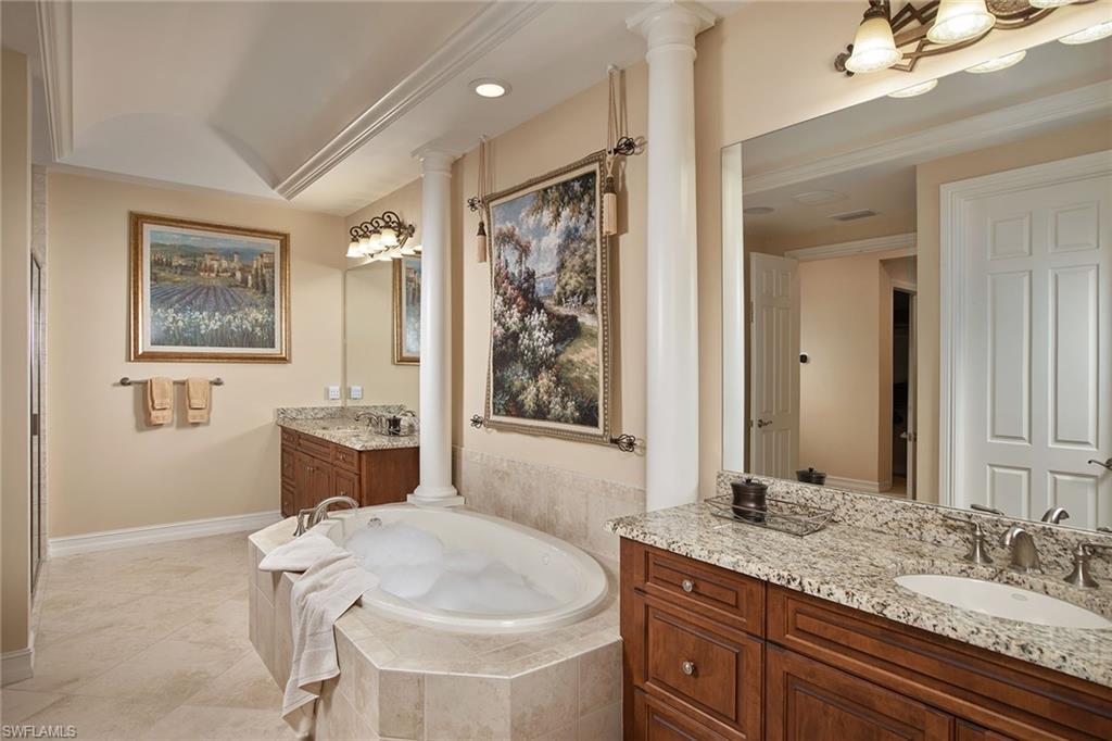 419 Saddlebrook Lane Naples, FL 34110 - Photo 12 of 24 a bathroom with a granite countertop sink and a mirror