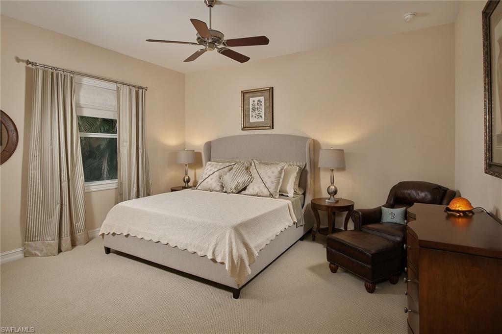 419 Saddlebrook Lane Naples, FL 34110 - Photo 14 of 24 a bedroom with a bed and ceiling fan