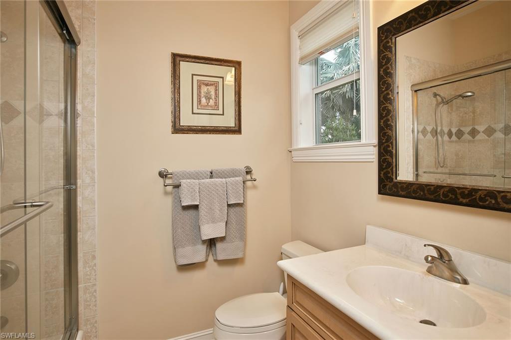 419 Saddlebrook Lane Naples, FL 34110 - Photo 15 of 24 a bathroom with a sink toilet and mirror