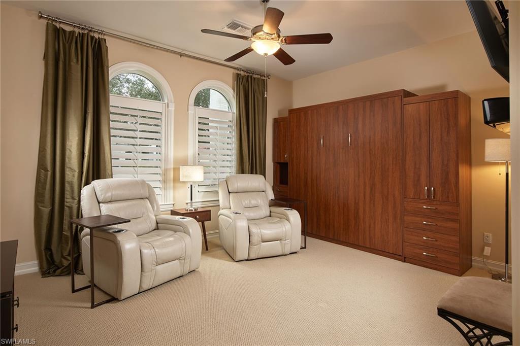 419 Saddlebrook Lane Naples, FL 34110 - Photo 16 of 24 a living room with furniture and a large window