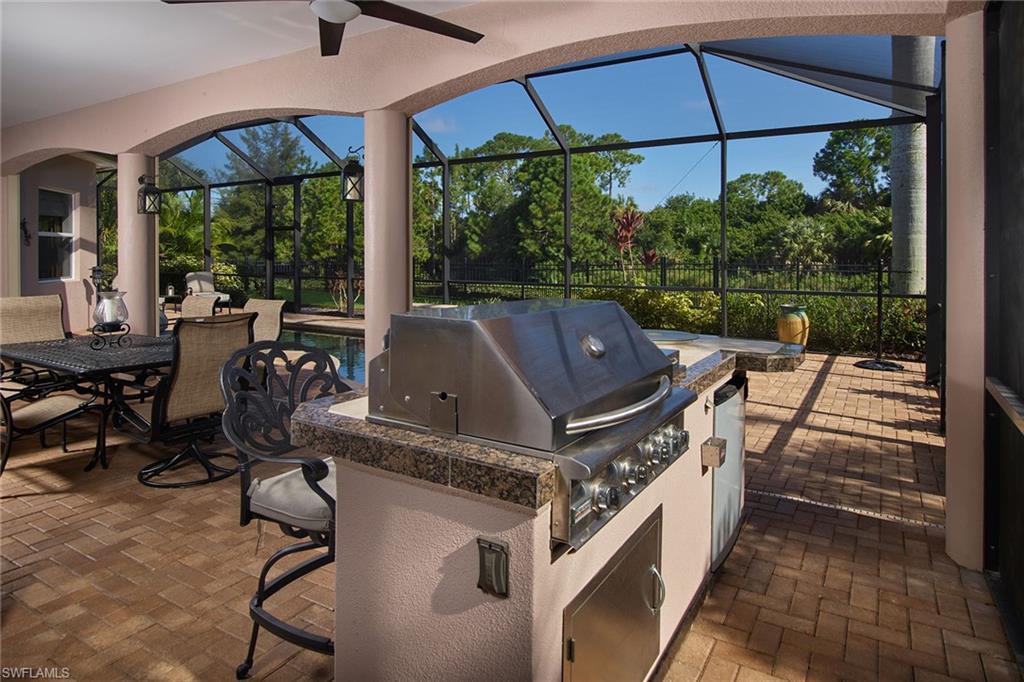 419 Saddlebrook Lane Naples, FL 34110 - Photo 18 of 24 a view of an outdoor sitting area with furniture and backyard