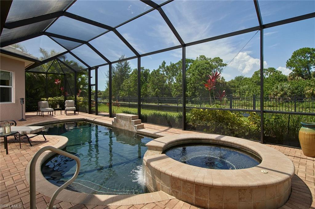 419 Saddlebrook Lane Naples, FL 34110 - Photo 20 of 24 a view of a swimming pool with a porch