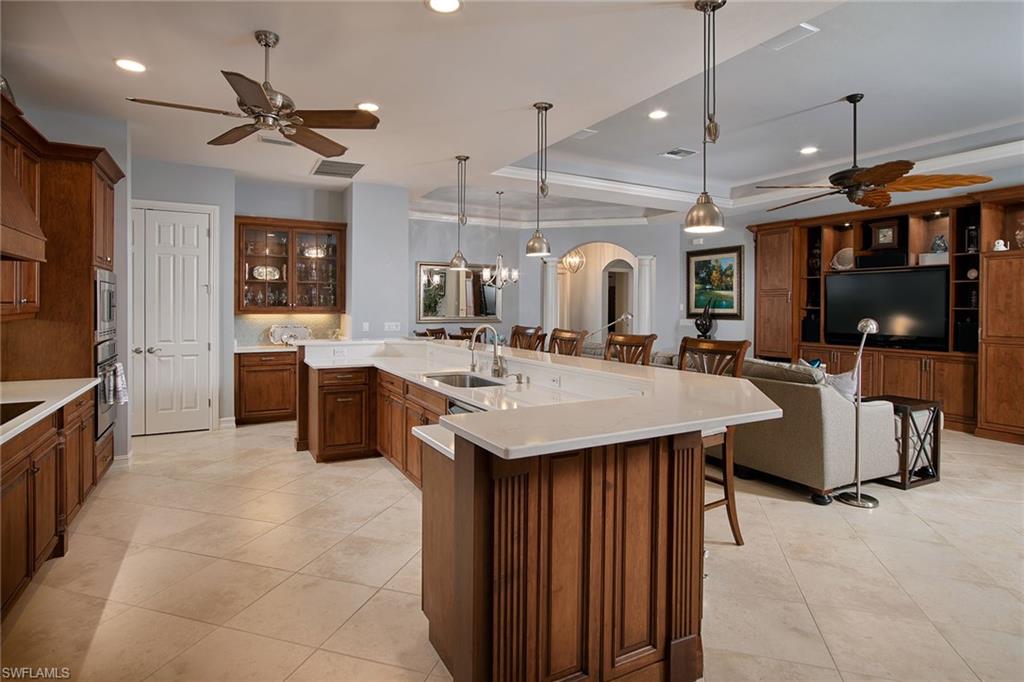 419 Saddlebrook Lane Naples, FL 34110 - Photo 5 of 24 a kitchen with a stove a refrigerator and a sink