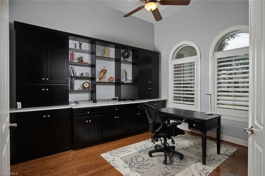 419 Saddlebrook Lane Naples, FL 34110 - Photo 10 of 24 a room with two chandeliers and furniture