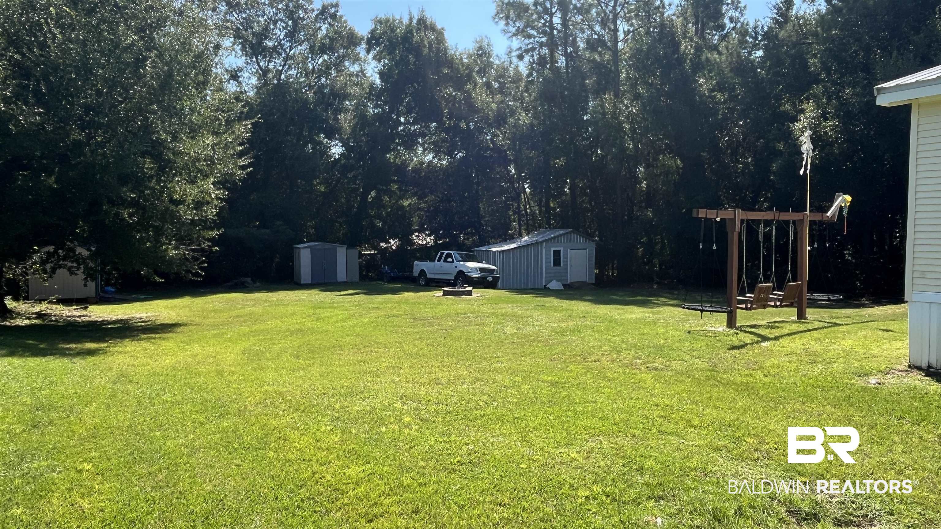 12932 Santa Piedro Street Lillian, AL 36549 - Photo 15 of 20 View of green lawn featuring a storage shed