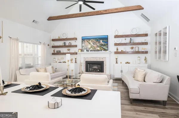 a living room with furniture and a fireplace
