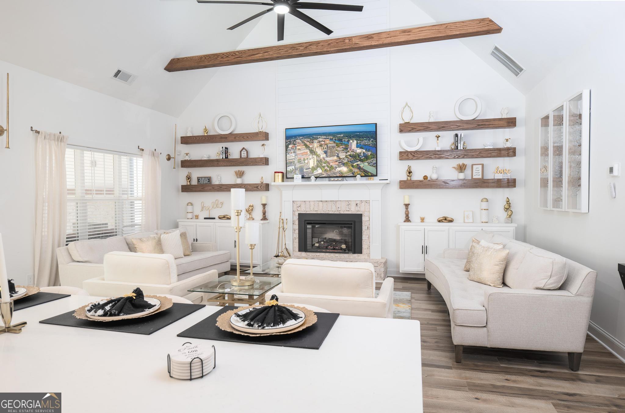 1016 Farmington Road Griffin, GA 30224 - Photo 11 of 31 a living room with furniture and a fireplace