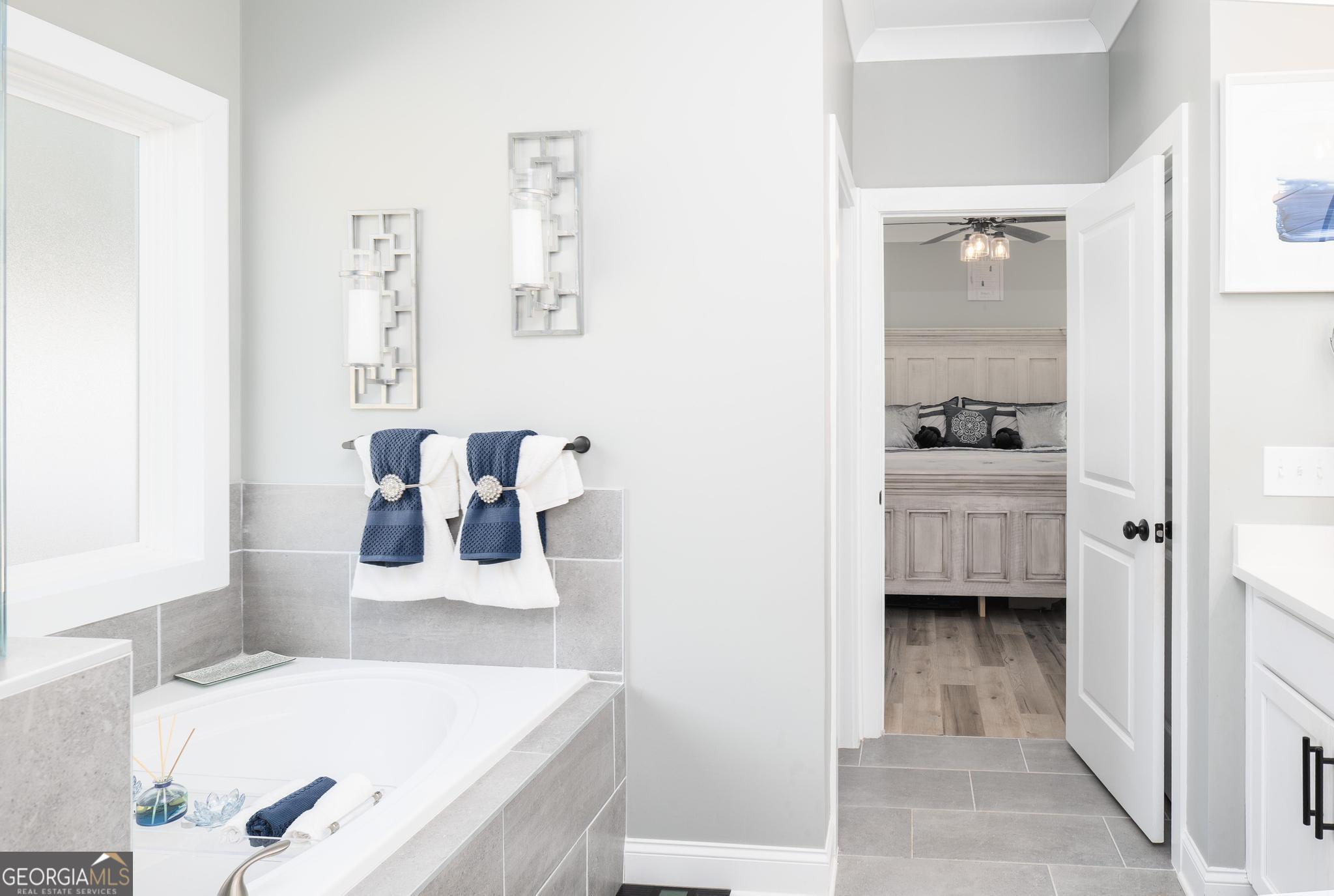 1016 Farmington Road Griffin, GA 30224 - Photo 19 of 31 a en suite bathroom with a tub sink and mirror