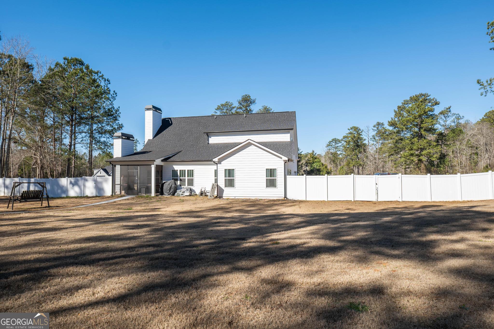 1016 Farmington Road Griffin, GA 30224 - Photo 30 of 31 a view of a big house with a big yard and large trees