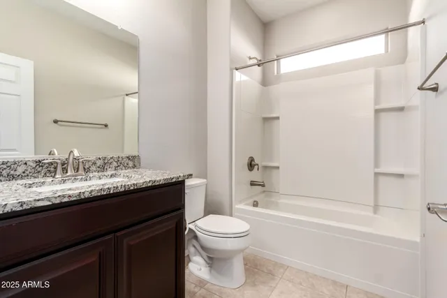 an empty room with a ceiling fan and carpet