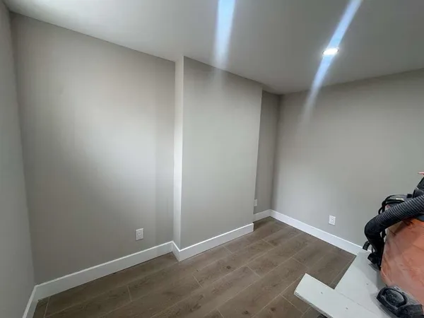 an empty room with wooden floor