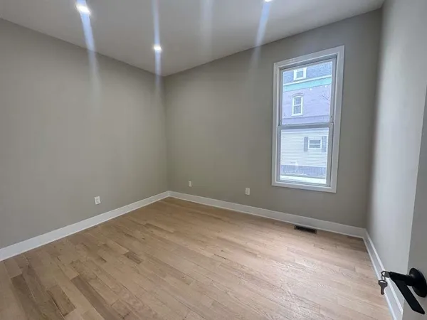 an empty room with a empty space and windows