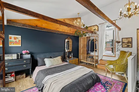 a bedroom with a bed furniture and a book shelf