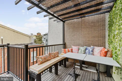 a view of a balcony with wooden floor and fence