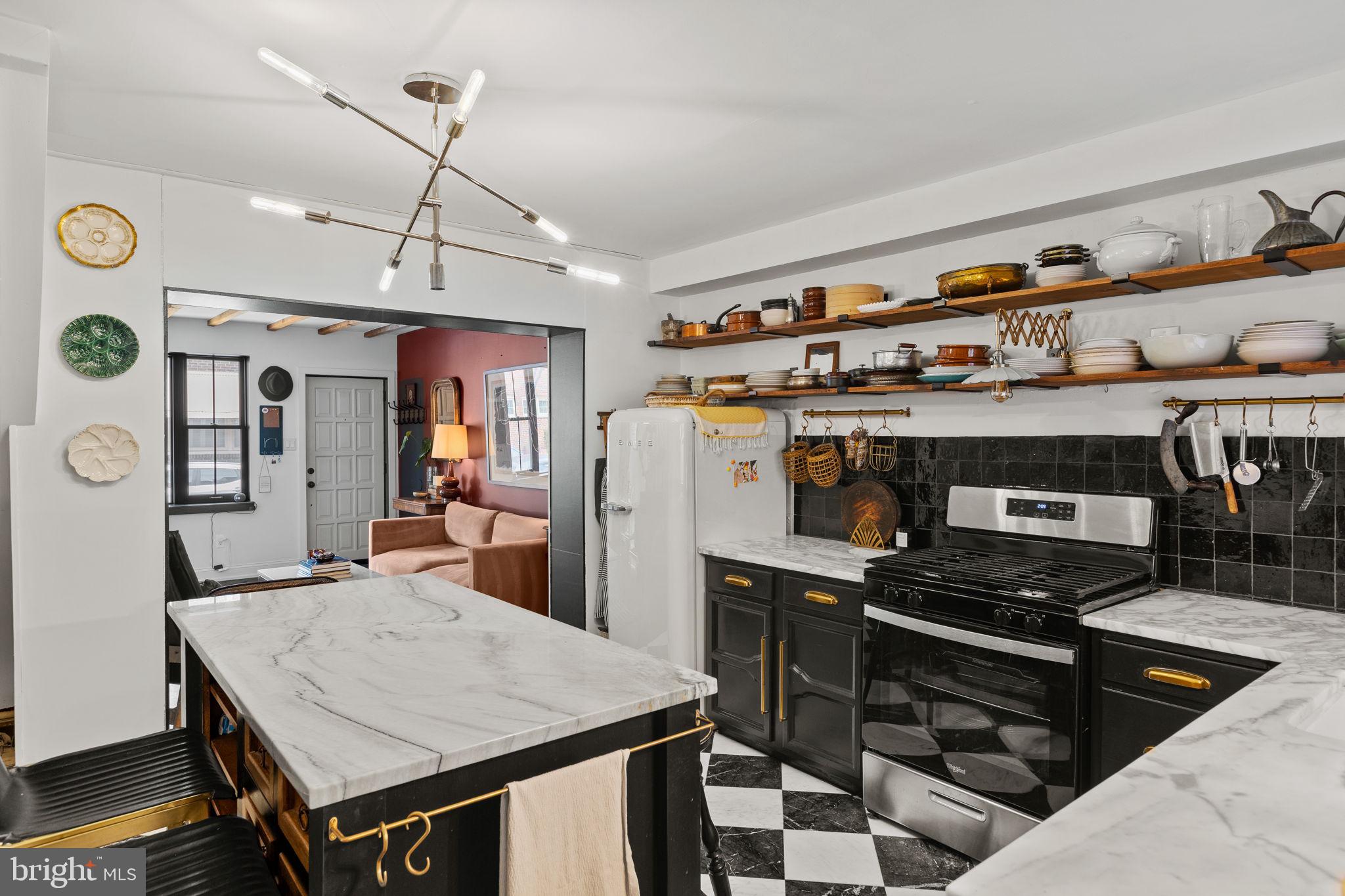 630 Fitzwater Street Philadelphia, PA 19147 - Photo 7 of 25 a kitchen with a stove a refrigerator and a dining table