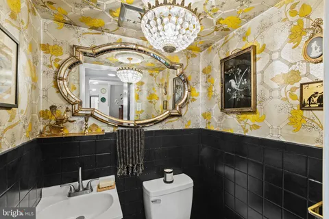 a bathroom with a sink mirror vanity and toilet