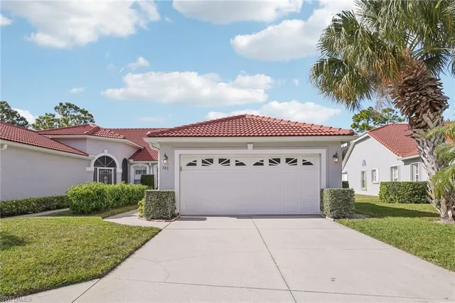 a front view of a house with a yard and garage